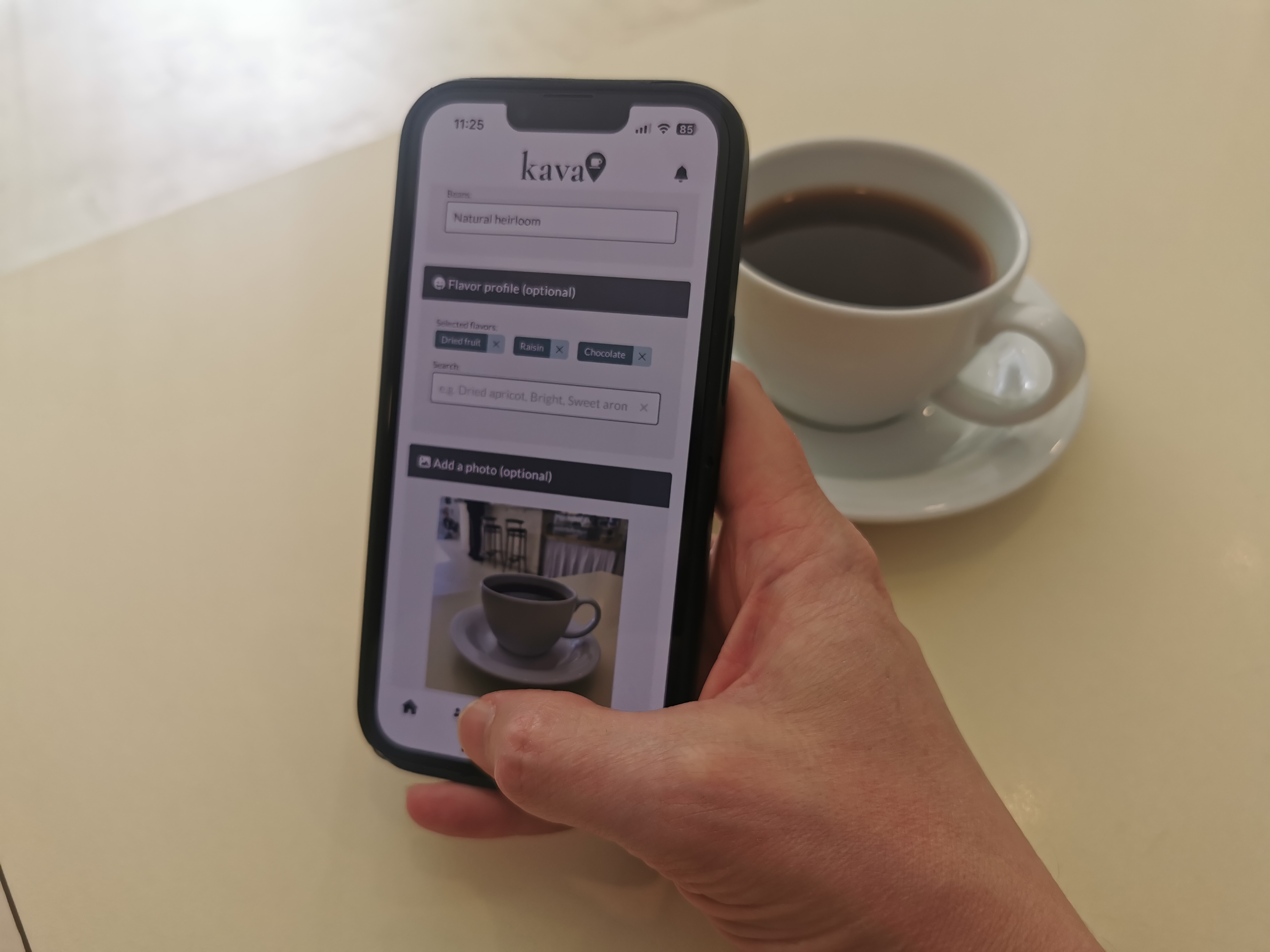 A person holding a phone using the Kava coffee app